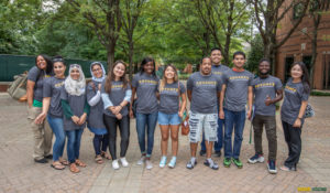 diverse group facing the camera wearing ADVANCE shirts