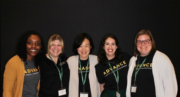 A group of ADVANCE Success Coaches smile together on campus.